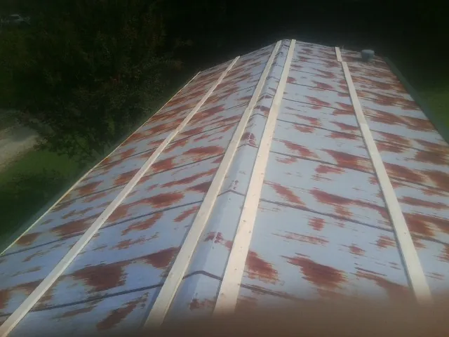 Rusted metal roof panels with new wood purlins before replacement — Storm Damage Roof Repair in Perkinsville by Roofing Brothers